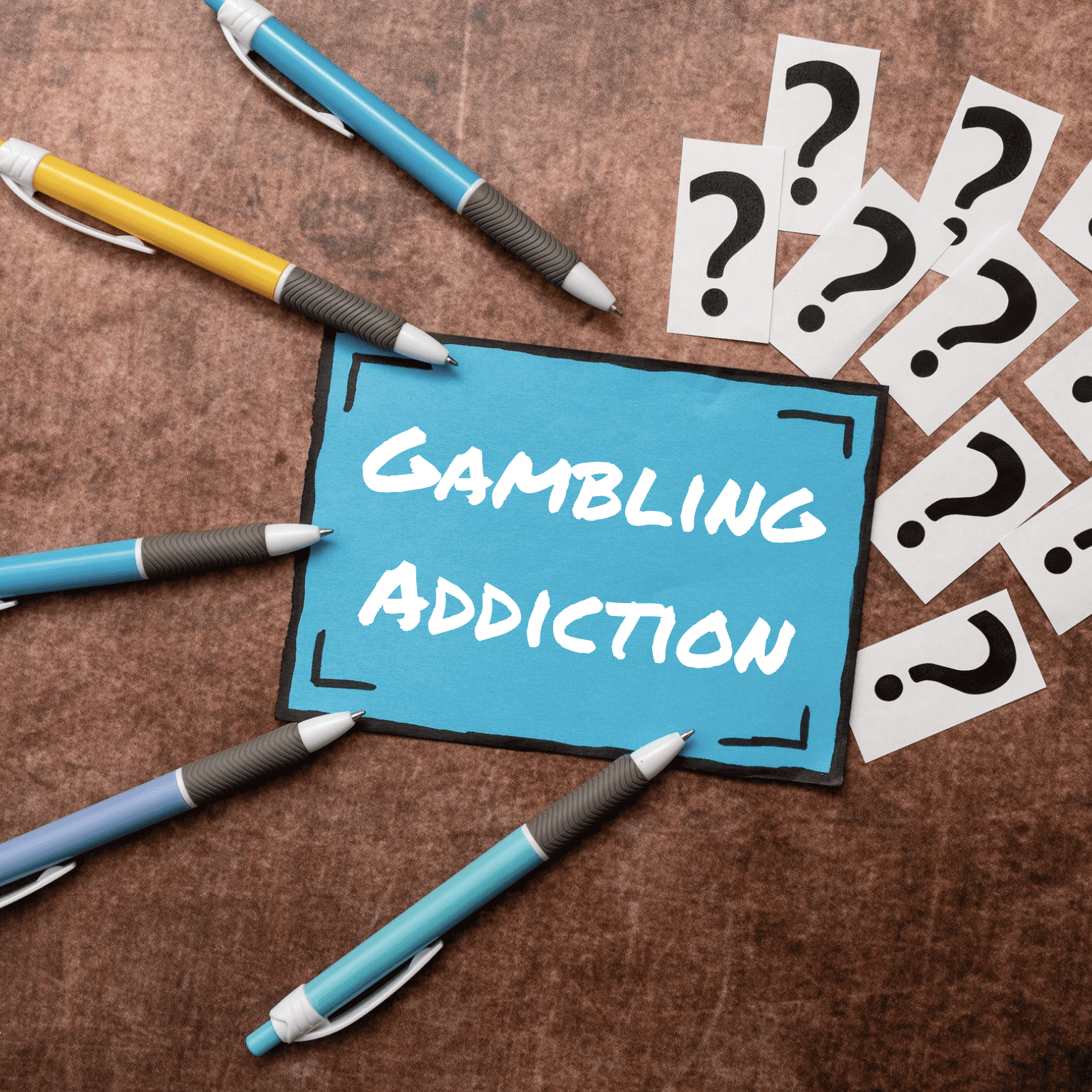 A note with gambling addiction on it surrounded by question marks